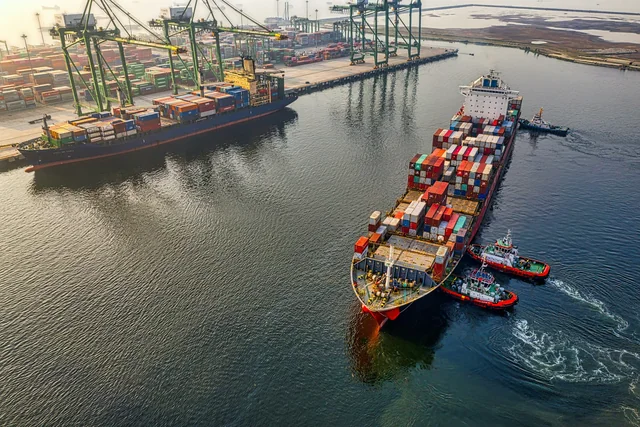 Container vessel alongside cranes in a modern international port