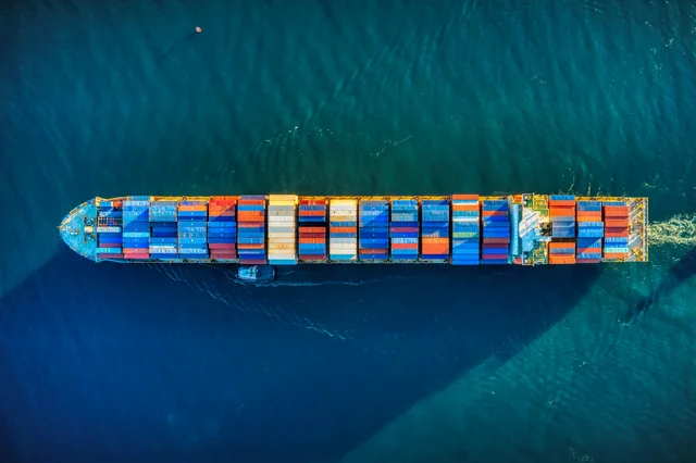 A container vessel crossing deep blue open water